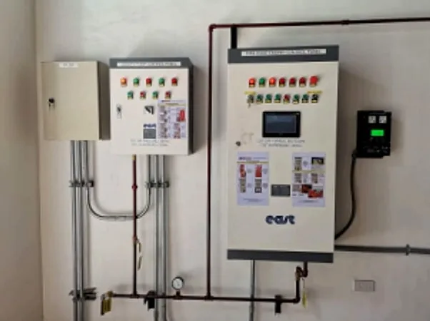 Control panels and electrical conduit installed on a white wall