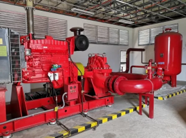 Red diesel-driven fire pump set with pressure tank in a pump room