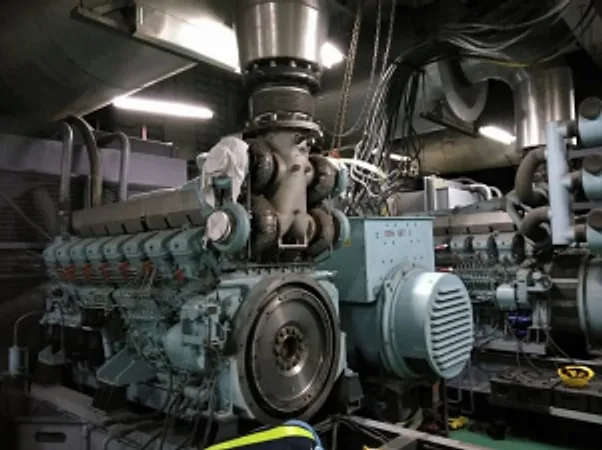 Large diesel engine and alternator in a generator room